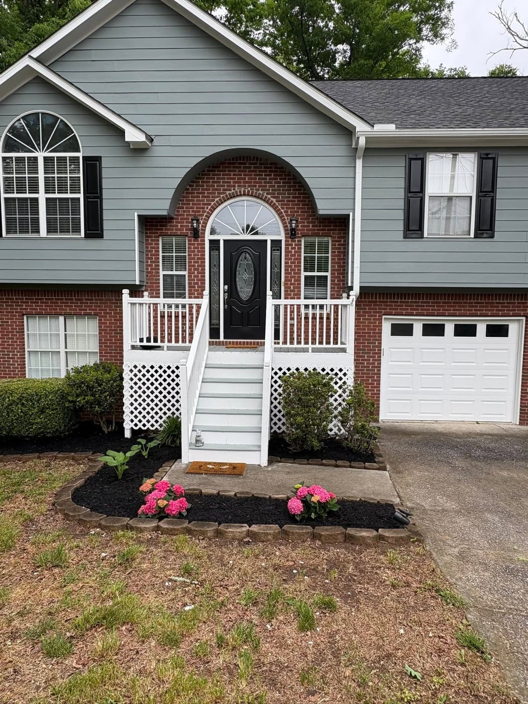 The front beds of a brick split-level home, after