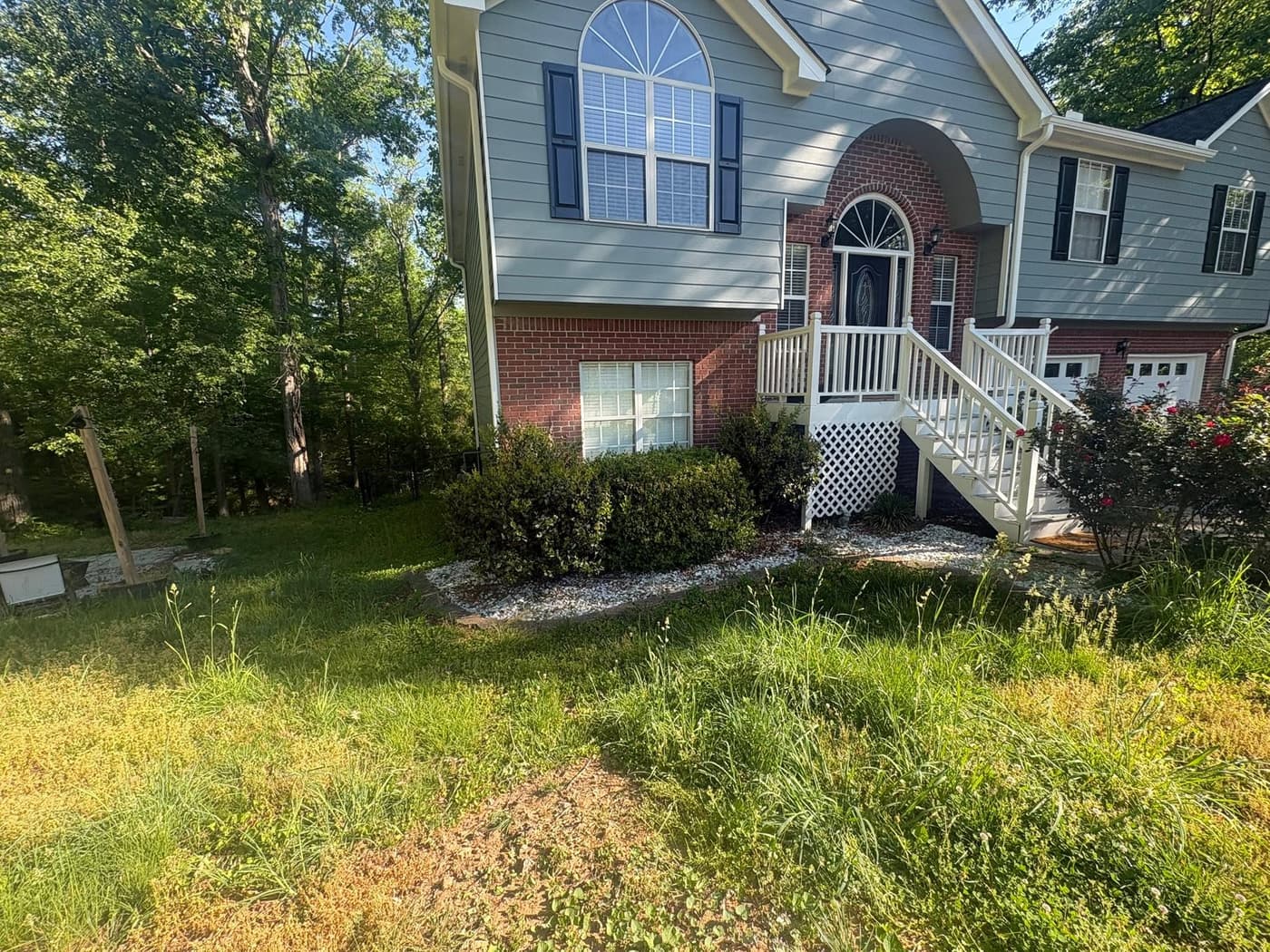 The front yard of a split-level home, before