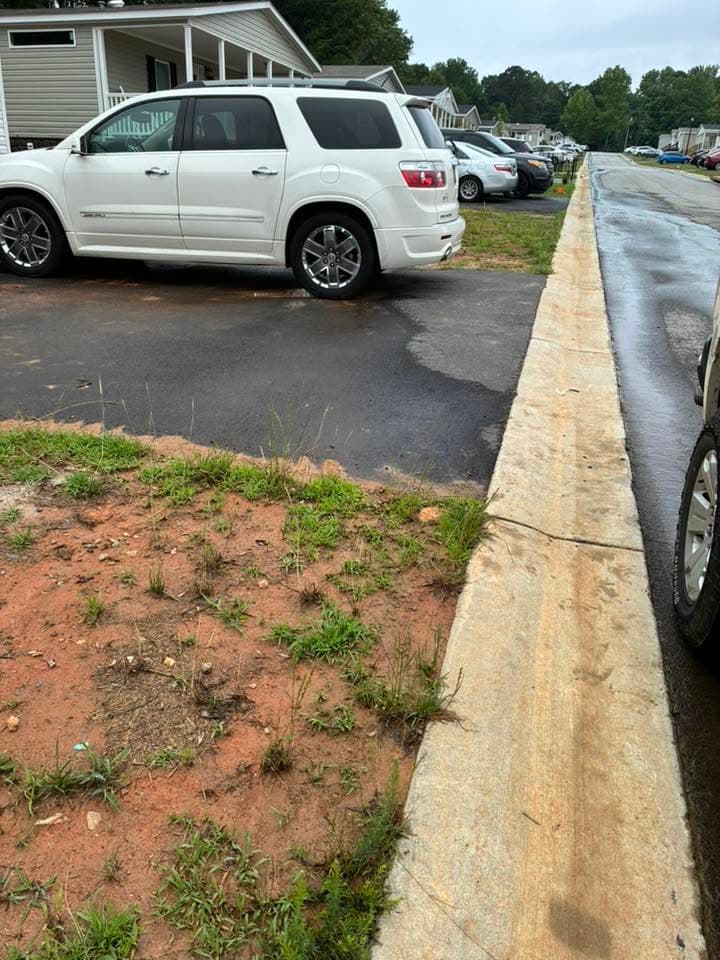 A driveway with a pile of bags, boxes and a TV, after