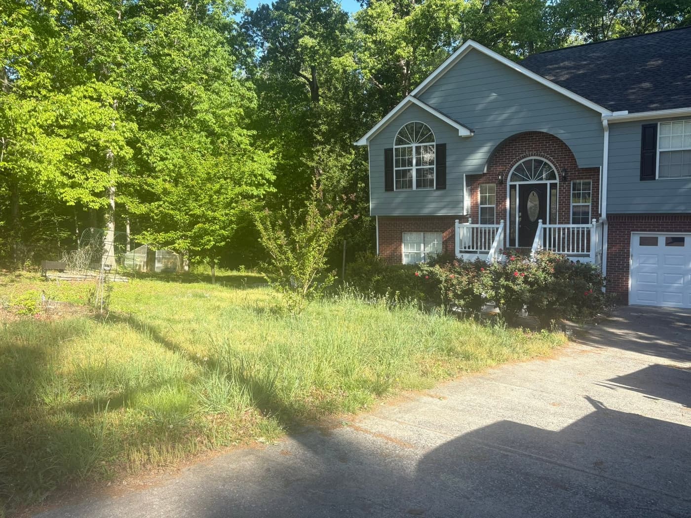Before: a split-level home with the front yard waist-high