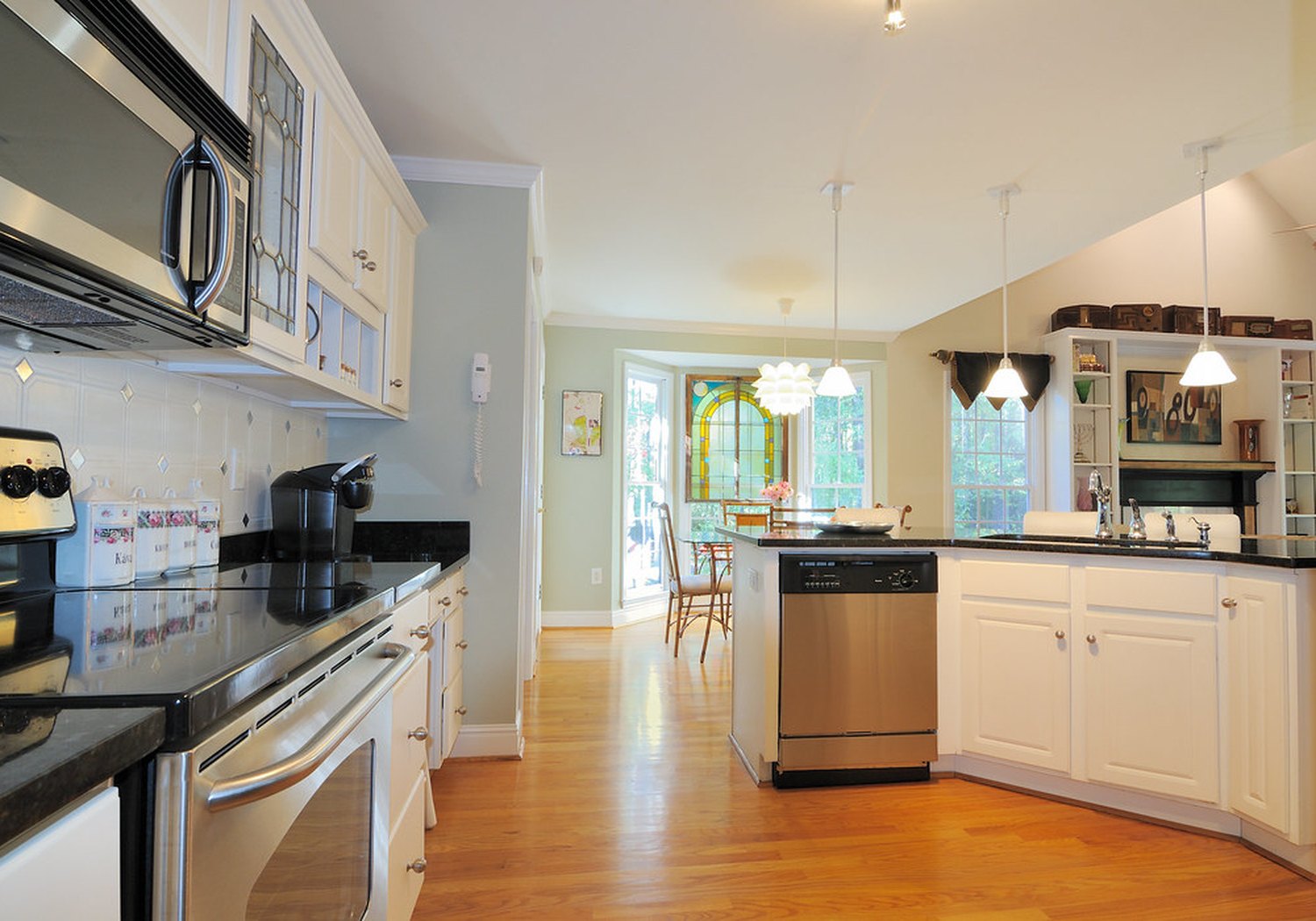 An open kitchen and living space with the counters clear and the floor done