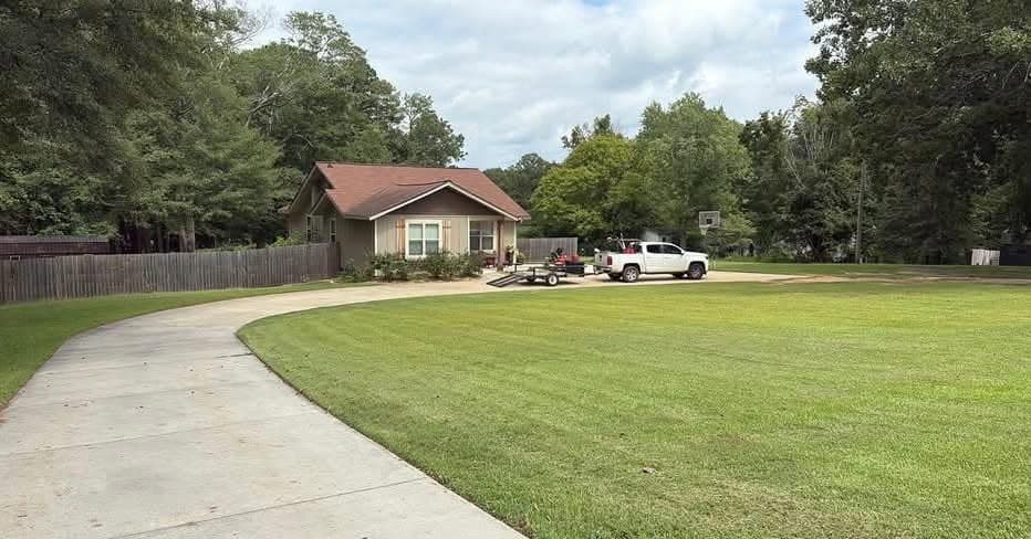 A freshly cut lawn in West Georgia, the Mason Worx truck and trailer parked at the road