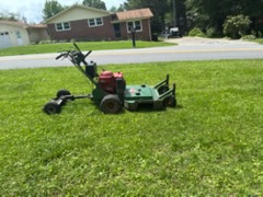 The Mason Worx walk-behind mower on a lawn mid-cut