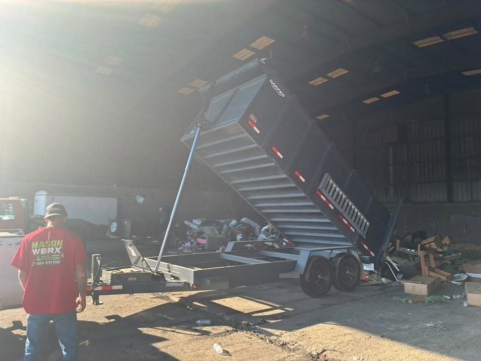 The dump trailer tipping a load at the end of a haul-off